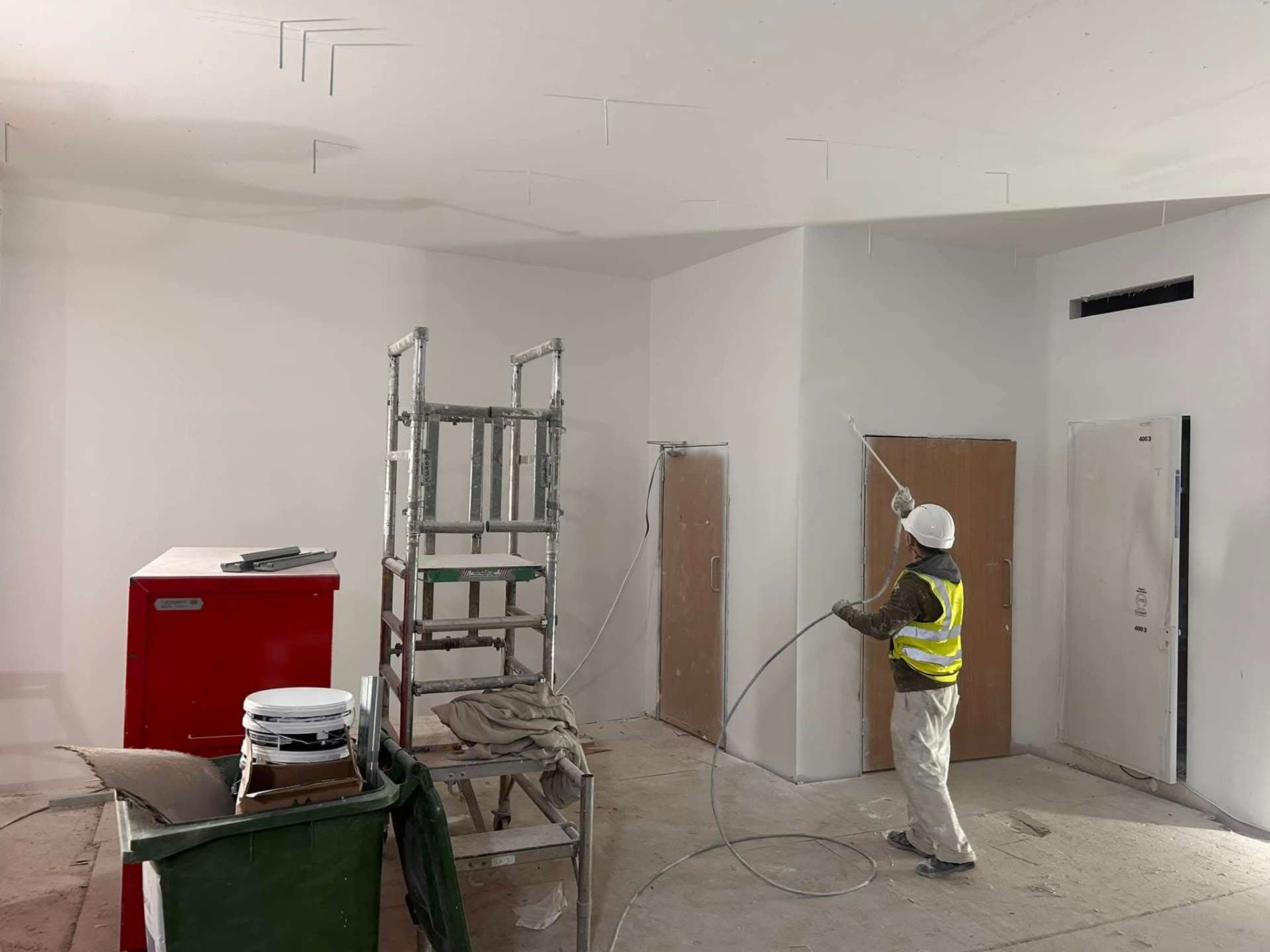 Professional spray painting on a commercial site